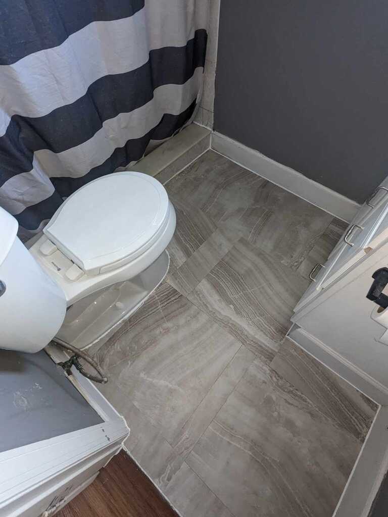 Bathroom tile floor by Fix It Once Handyman Services — New porcelain plank tile laid and grouted
