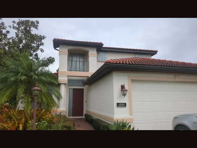 Exterior house paint by Fix it Once Handyman Services — Two-tone stucco refresh on a Venice tile-roof home