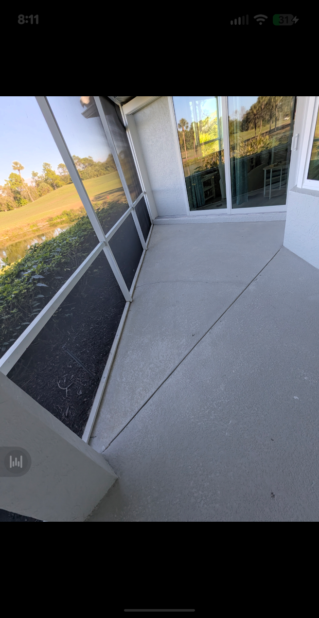 Lanai — before by Fix It Once Handyman Services — Bare, stained concrete lanai before deck coating